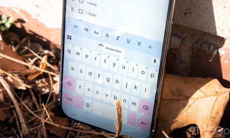 Smartphone displaying Gboard keyboard app on a task list, outdoors.