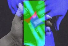 Hand holding smartphone with colorful, abstract AI interface on the screen.
