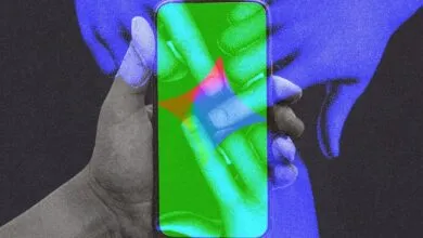Hand holding smartphone with colorful, abstract AI interface on the screen.