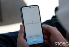 Person holds phone displaying 'Hi Damien, let's get into it' on a white screen.