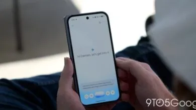 Person holds phone displaying 'Hi Damien, let's get into it' on a white screen.
