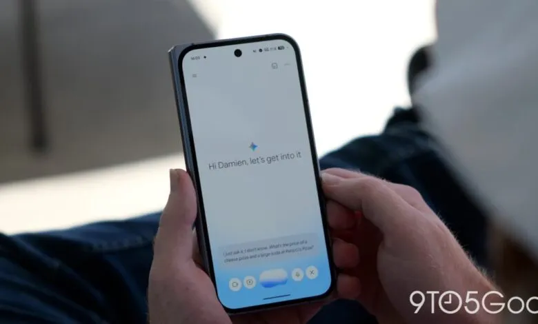 Person holds phone displaying 'Hi Damien, let's get into it' on a white screen.