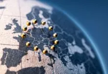 Globe map of Europe with golden pins forming EU flag stars.