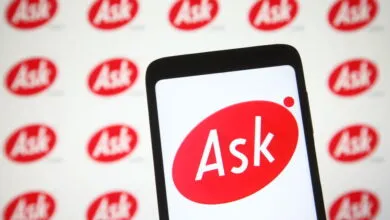 Ask.com logo displayed on a smartphone screen with a repeating logo background.