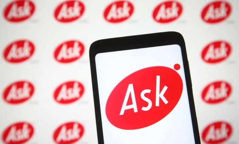 Ask.com logo displayed on a smartphone screen with a repeating logo background.