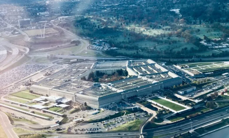 Aerial view of the Pentagon building, surrounded by roads, parking lots, and greenery.
