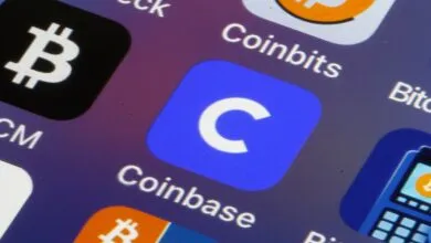 Close-up of phone screen showing Bitcoin, Coinbits, and Coinbase app icons.