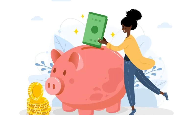 Woman putting money into a pink piggy bank with gold coins nearby.