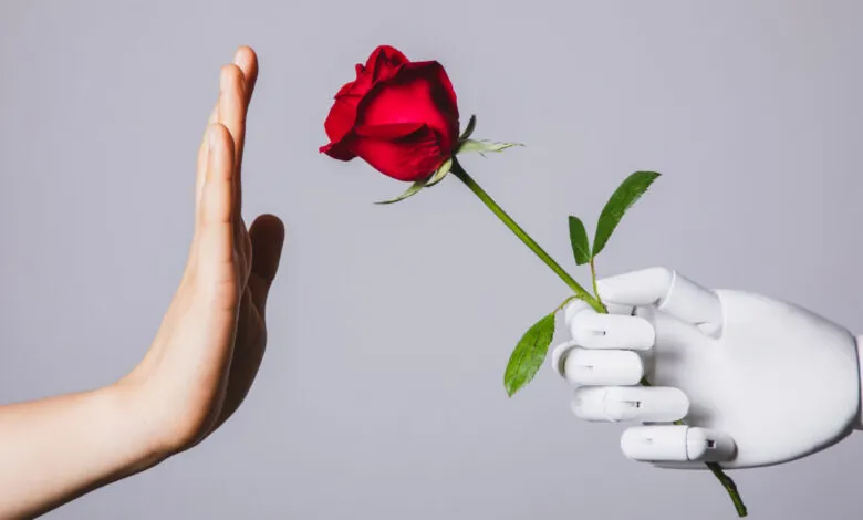 Human hand rejects a red rose offered by a white robotic hand.