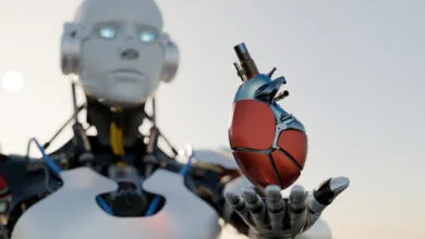 Android robot holding a mechanical heart in its outstretched hand.