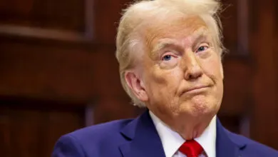 Close-up portrait of Donald Trump in a suit and red tie.