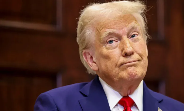 Close-up portrait of Donald Trump in a suit and red tie.