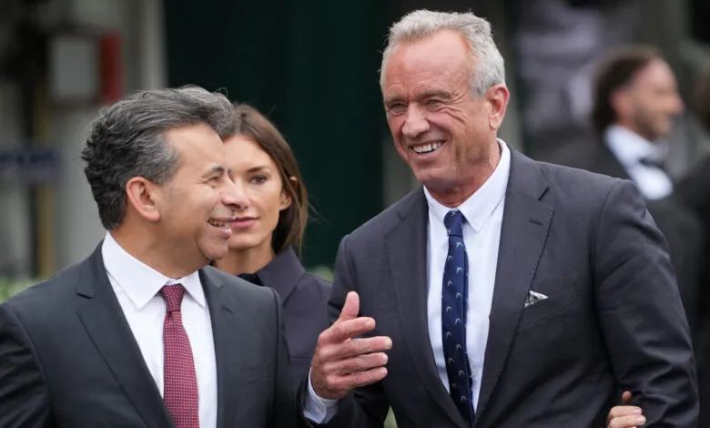 Robert F. Kennedy Jr. and Martin Makary walk together, smiling.