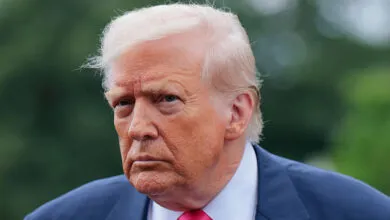 Close-up of Donald Trump in suit and pink tie.