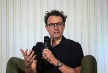 Dario Amodei speaks into microphone, gesturing with hand.