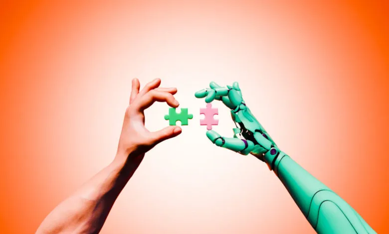 Human and robot hands connect puzzle pieces, symbolizing collaboration.