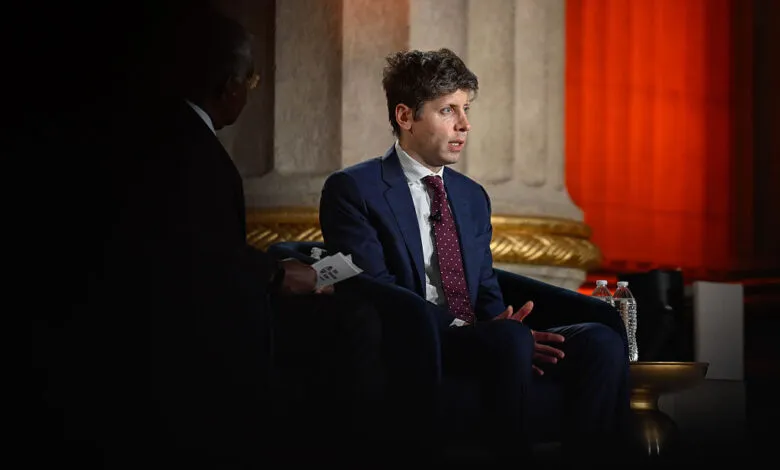 Sam Altman speaks at BlackRock's Infrastructure Summit, wearing a suit and tie.