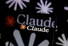 Smartphone displaying the Claude AI logo against a floral background.