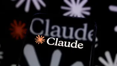 Smartphone displaying the Claude AI logo against a floral background.
