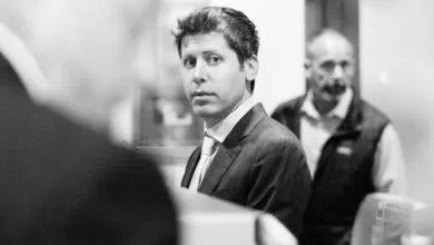 Black and white portrait of man in suit looking at camera.