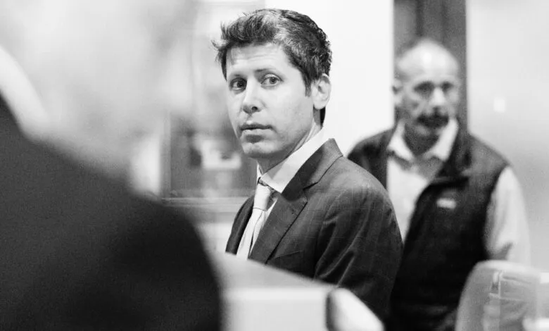 Black and white portrait of man in suit looking at camera.