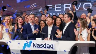 Group celebrates ERVO's IPO at Nasdaq, confetti falling.