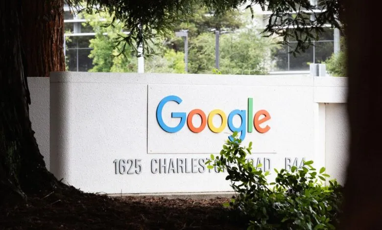 Google sign at 1625 Charleston Road, framed by trees.