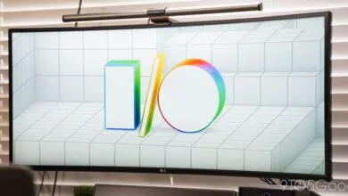 Curved monitor displaying the Google I/O logo on a tiled background.