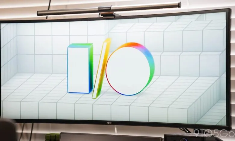 Curved monitor displaying the Google I/O logo on a tiled background.