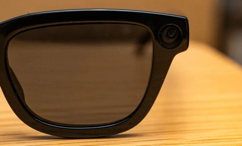 Close-up of black smart glasses with a camera on the right lens.