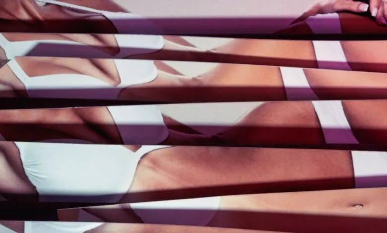 Abstract image of a woman's body in white lingerie, fragmented by horizontal lines.