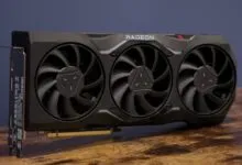 Black Radeon graphics card with three fans on a wooden surface.