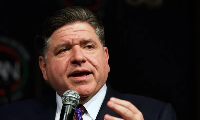 Illinois Governor J.B. Pritzker speaking into a microphone.
