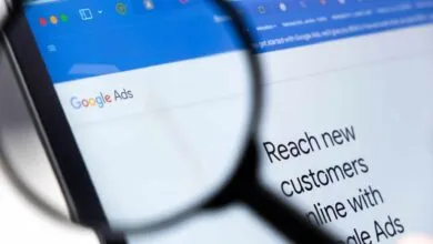 Close-up of a Google Ads webpage being viewed through a magnifying glass.