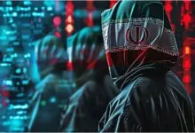 Person in Iranian flag hoodie stands before digital code.