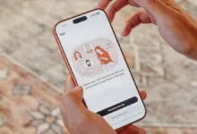 Person holding phone displaying Kin health app interface.