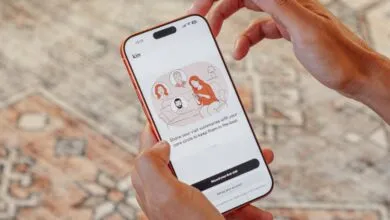 Person holding phone displaying Kin health app interface.