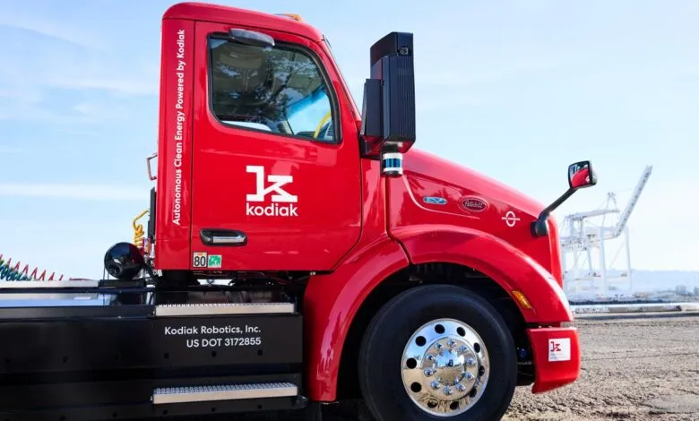Bright red Kodiak Robotics autonomous truck with company logo and 'Autonomous Clean Energy' text.