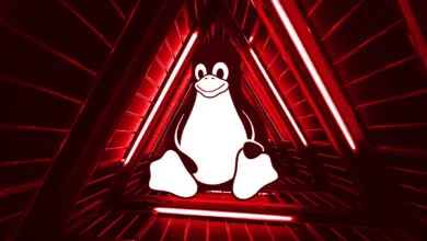 Tux the Linux penguin inside a red triangular tunnel with bright lights.