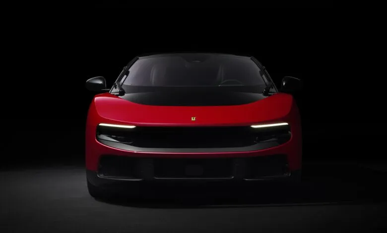 Front view of a red Ferrari Purosangue SUV against a dark background.