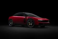 Red Ferrari Purosangue SUV with black accents on a dark background.