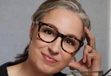Close-up portrait of Manoush Zomorodi wearing glasses and smiling.