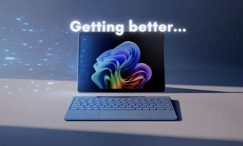 Microsoft Surface tablet with keyboard, displaying Windows 11 desktop and 'Getting better...' text.