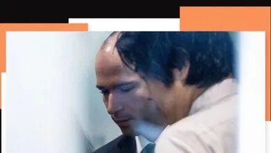 Close-up of Greg Brockman with another person, looking down.