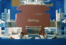 Musely box on automated packaging machine, ready for assembly.
