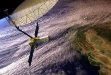 Satellite with large radar antenna orbiting Earth, showing clouds and landmasses.