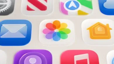 Close-up of iOS app icons with a frosted glass effect.