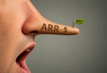 Person with long wooden nose that reads 'ARR $' and a sprouting leaf.
