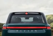 Rear view of a Rivian vehicle with distinctive horizontal taillight and 'RIVIAN' lettering.