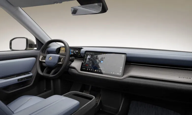 Interior view of a Rivian vehicle showcasing the dashboard and front seats.